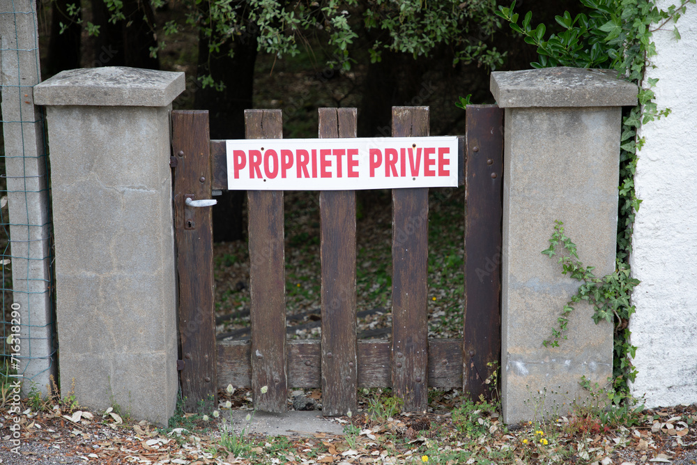 Red Private Property sign french text panel in France Propriete Privee on wooden door Red Private Property sign french text panel in France Propriete Privee on wooden door
