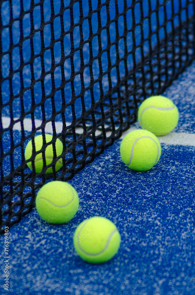 five balls on a paddle tennis court, selective focus