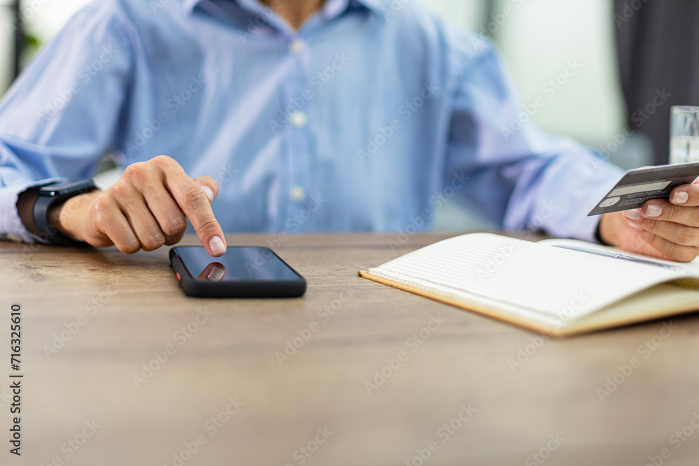 Woman using credit card and digital tablet in the office. Woman using credit card and digital tablet in the office.
