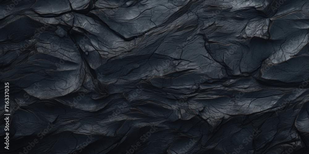 Close-up shot of a rugged black rock surface, showcasing intricate textures and shadows. Close-up shot of a rugged black rock surface, showcasing intricate textures and shadows.