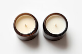  two unused white hand-poured soy wax scented candles in brown glass jars  on white background