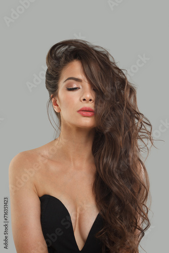 Lovely stylish young woman with perfect healthy skin and long hair on white background, studio fashion beauty portrait