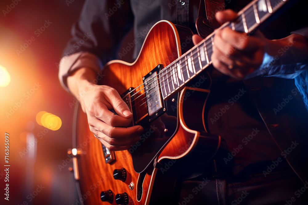 Obraz premium Guitar player performs on stage. Rock guitarist plays solo on an electric guitar.