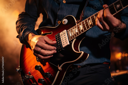 Guitar player performs on stage. Rock guitarist plays solo on an electric guitar.