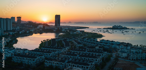 Sunrise with view over the landscaped islands with construction sites in Halong City, Vietnam photo