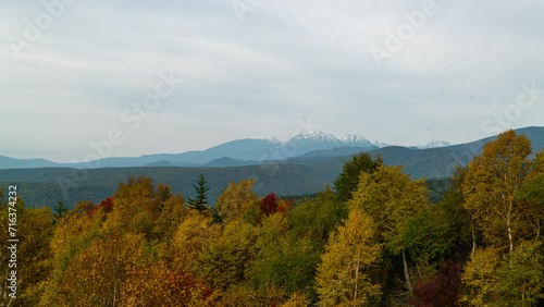 Timelapse of autumn leaves over Mount Taisetsuzan in Hokkaido, Japan photo