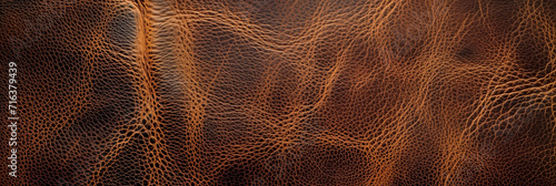 Close-up texture of brown leather material with natural patterns, suitable for backgrounds or design elements in fashion and upholstery projects photo