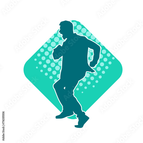 Silhouette of a slim man dancing pose. Silhouette of a male dancer in action pose.