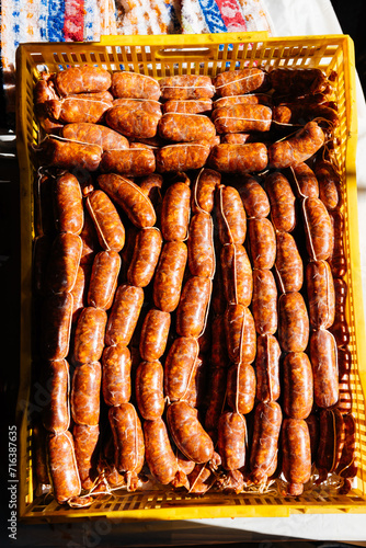 Raw homemade sausages placed in container