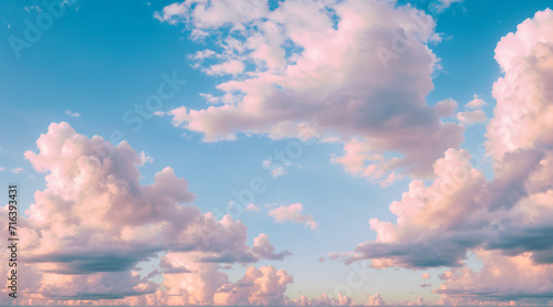 Pastel pink fluffy clouds at sunrise.  photo