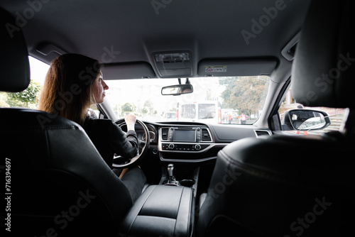 Woman in black clothes driving luxurious car © 4Max
