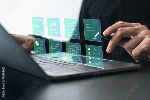 Businessman working on tablet with business and financial paperless report file, contract, plan, data and information. .Online e-document management and paperless workflow or office concept
