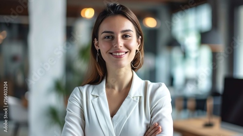 Happy confident businesswoman in office looking at camera