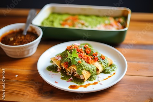 spicy pork enchiladas with red and green sauce drizzle