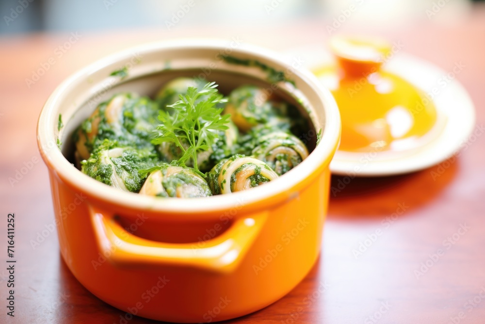 escargot with herb-garlic sauce in ceramic pot