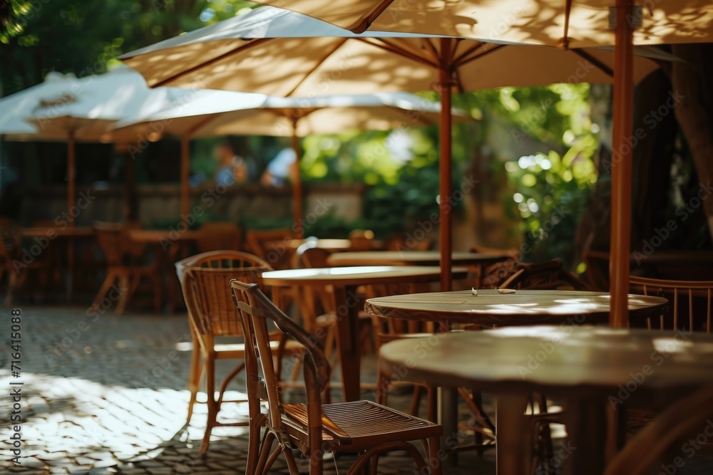 A row of tables and chairs with umbrellas providing shade. Perfect for outdoor dining or relaxation areas