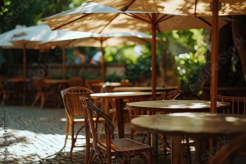 A row of tables and chairs with umbrellas providing shade. Perfect for outdoor dining or relaxation areas