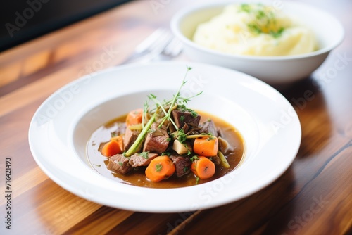 beef bourguignon served with a side of mashed potatoes