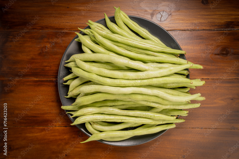Green bean or Green pea in wooden plate on wooden background. Green bean or Green pea in wooden plate on wooden background.