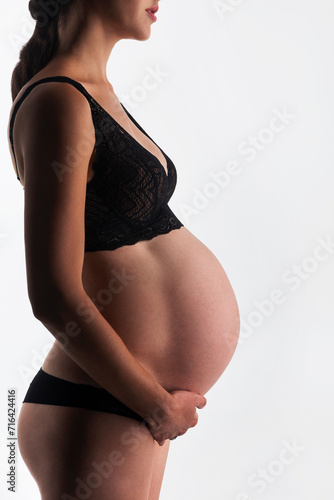 Young pregnant woman in studio