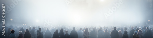 abstract silhouettes of crowds of people in the fog  long narrow panoramic view   blurred light background urban view traffic
