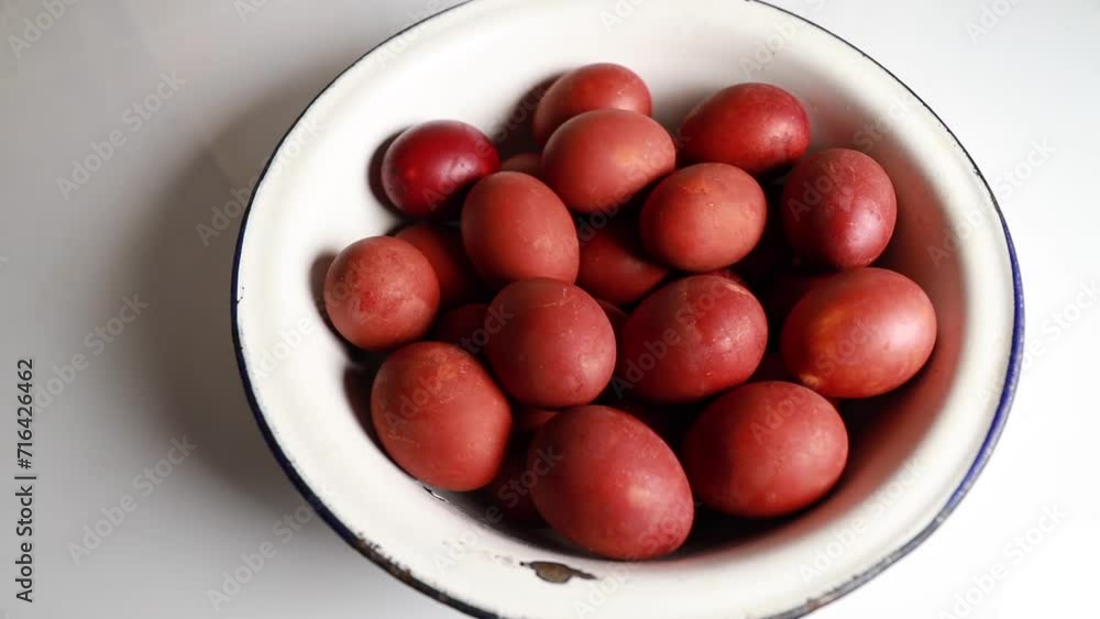 A large bowl of Easter red eggs, placed on a table, with a copyspace. Banner A large bowl of Easter red eggs, placed on a table, with a copyspace. Banner