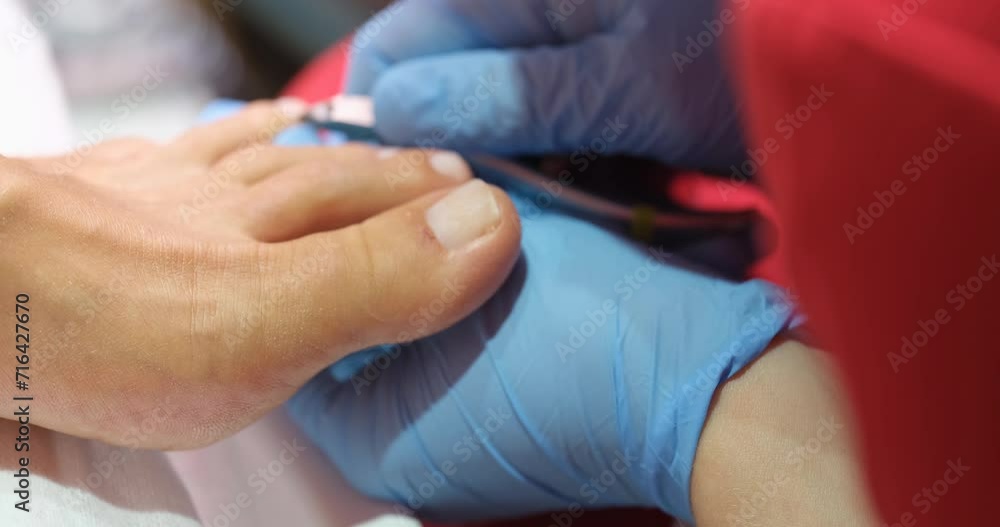 Pedicure specialist cuts female toenails in a beauty salon. Manicure and pedicure services Pedicure specialist cuts female toenails in a beauty salon. Manicure and pedicure services