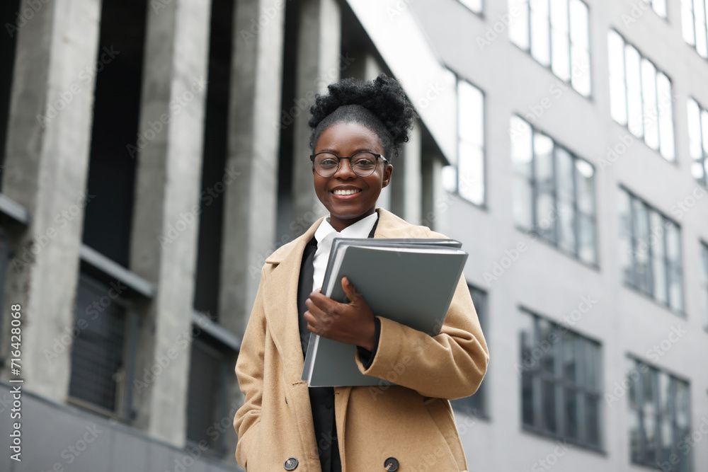 Happy woman with folders outdoors. Lawyer, businesswoman, accountant or manager Happy woman with folders outdoors. Lawyer, businesswoman, accountant or manager
