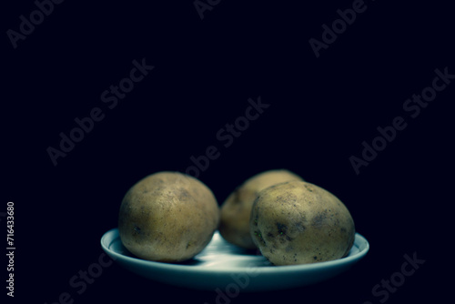 Basket with fresh potatoes,Crop peruvian farmer in bright traditional costume showing heap of freshly picked potato at camera in field in chinchero,High angle view of potatoes and onions in crates at 