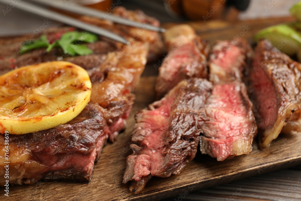 Delicious grilled beef steak on table, closeup