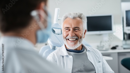 An uplifting image featuring a senior male patient smiling at a healthcare professional, conveying trust and positivity in a medical setting. photo