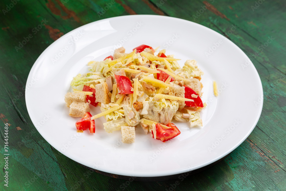 Classic Caesar salad with tomato, cheese, croutons, chicken and lettuce. Classic Caesar salad with tomato, cheese, croutons, chicken and lettuce.