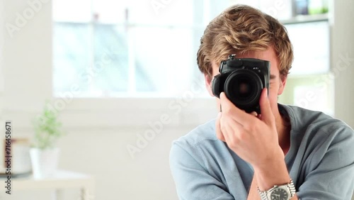 Camera, photography and face of man in home for creative career, job and working. Happy, photographer and portrait of person in apartment with digital equipment for taking pictures for portfolio photo