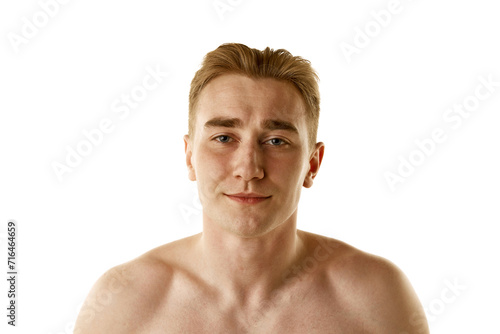 Portrait of young handsome guy standing shirtless isolated on white background. Skin care morning routine. Concept of male beauty, skin care, cosmetology and cosmetics, health. Ad for beauty products