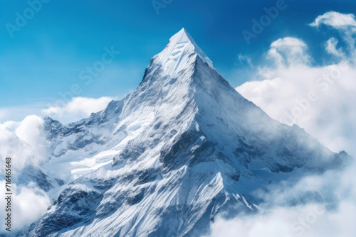A majestic snowy mountain peak towering above the clouds, its pristine white slopes contrasting against the deep blue sky.