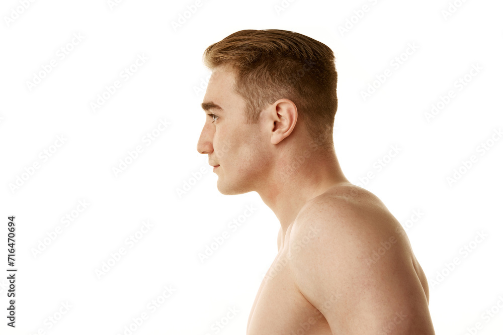 Shirtless young guy with redhead, clear, spotless skin standing isolated over white background. Concept of male beauty, skin care, cosmetology and cosmetics, health