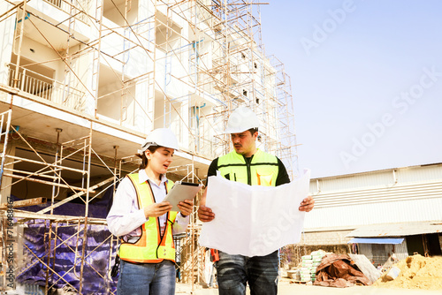 Male and female architects caucasian oversee construction new condominium civil engineers inspect blueprints advise planning residential projects real estate luxury and environmentally friendly.