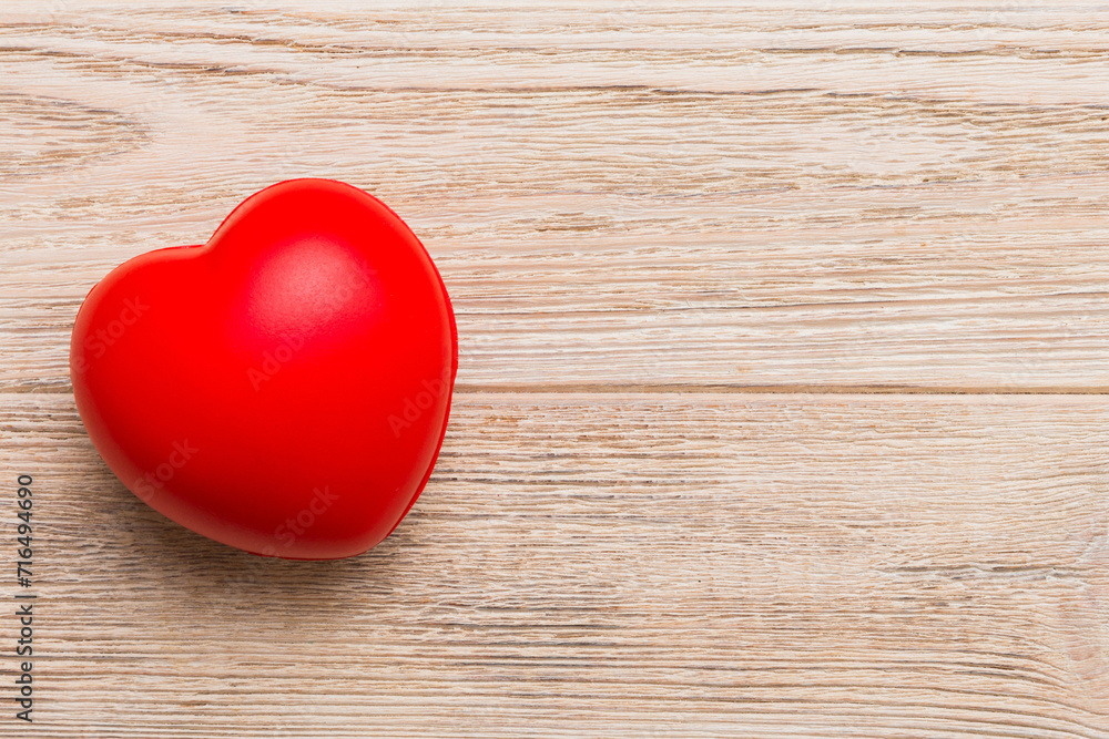 red heart shape on colored background. minimal concept top view with copy space
