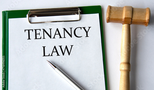 TENANCY LAW - words on a white sheet on a white background and a judge's gavel