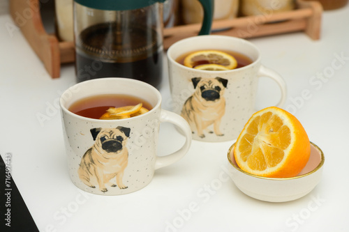black tea with lemon in cups with a drawn pug 2