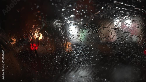 Wallpaper Mural Raindrops on car windshield. Car standing on streets of evening city, blurred background of traffic light and moving cars with street lights. Torontodigital.ca