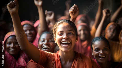 a woman in a red shirt is raising her hands