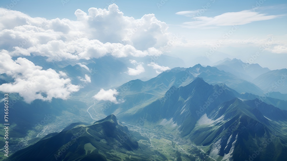 Fototapeta premium Swirling clouds over towering mountains in the summer , Swirling clouds, towering mountains, summer