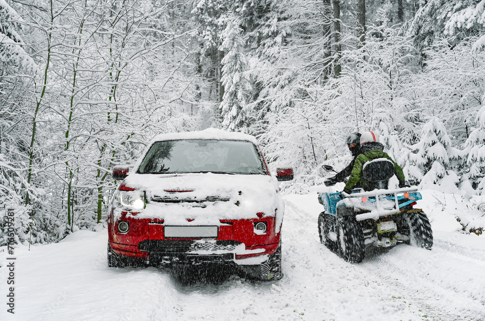 Car and atv in the snow