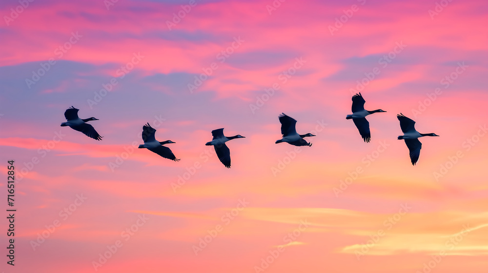 Migratory birds in flight against a colorful sky during seasonal journey. World wildlife day