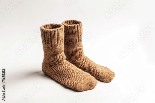 A pair of camel wool socks on white background