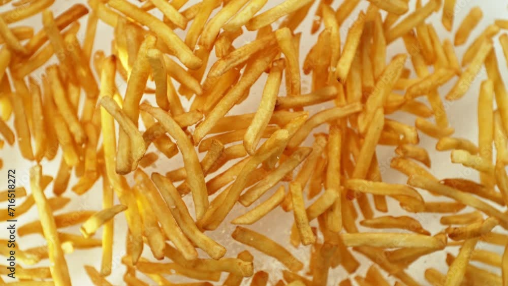 Super Slow Motion of Flying French Fries up in the Air on White Background. Filmed on High Speed Cinema Camera, 1000 fps. Super Slow Motion of Flying French Fries up in the Air on White Background. Filmed on High Speed Cinema Camera, 1000 fps.