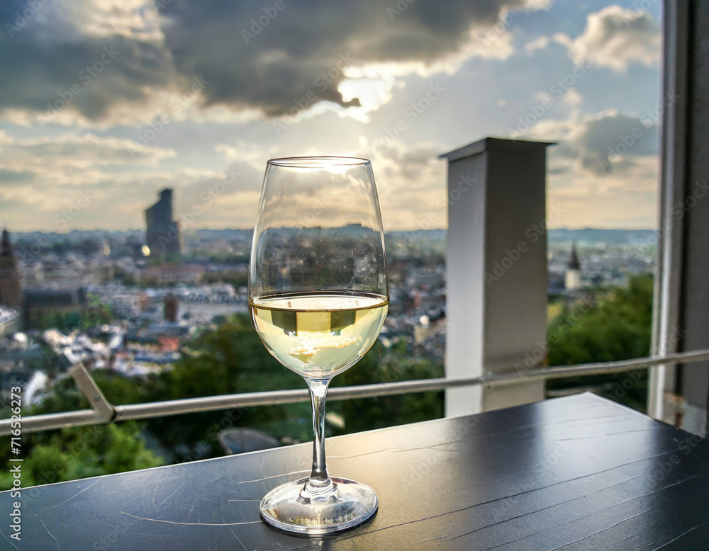 Glass of white wine against the background of the city Glass of white wine against the background of the city