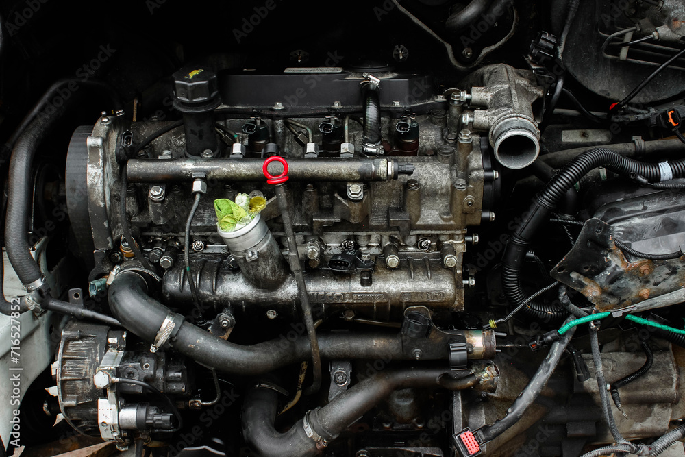 Open hood of a truck. Disassembled engine. Disassembled car. Car engine room under maintenance. Car service station. Car repair Open hood of a truck. Disassembled engine. Disassembled car. Car engine room under maintenance. Car service station. Car repair