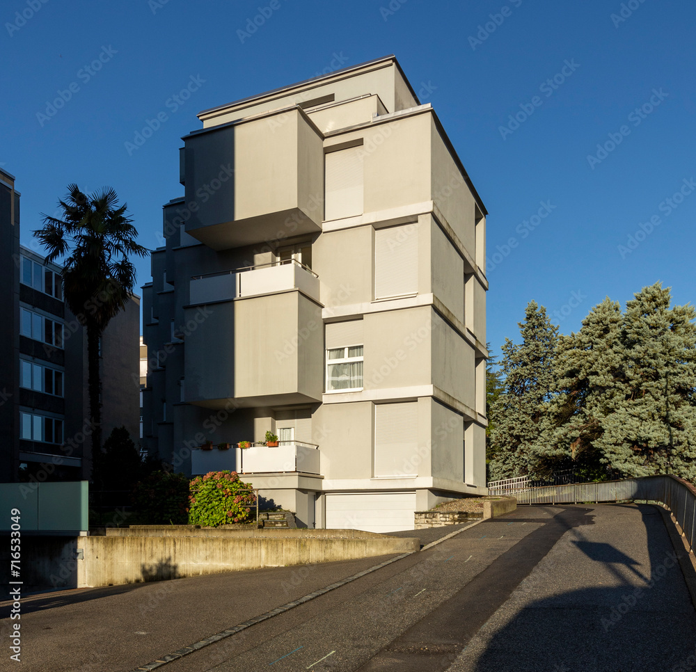 Exterior view of an old rough concrete apartment building with ...